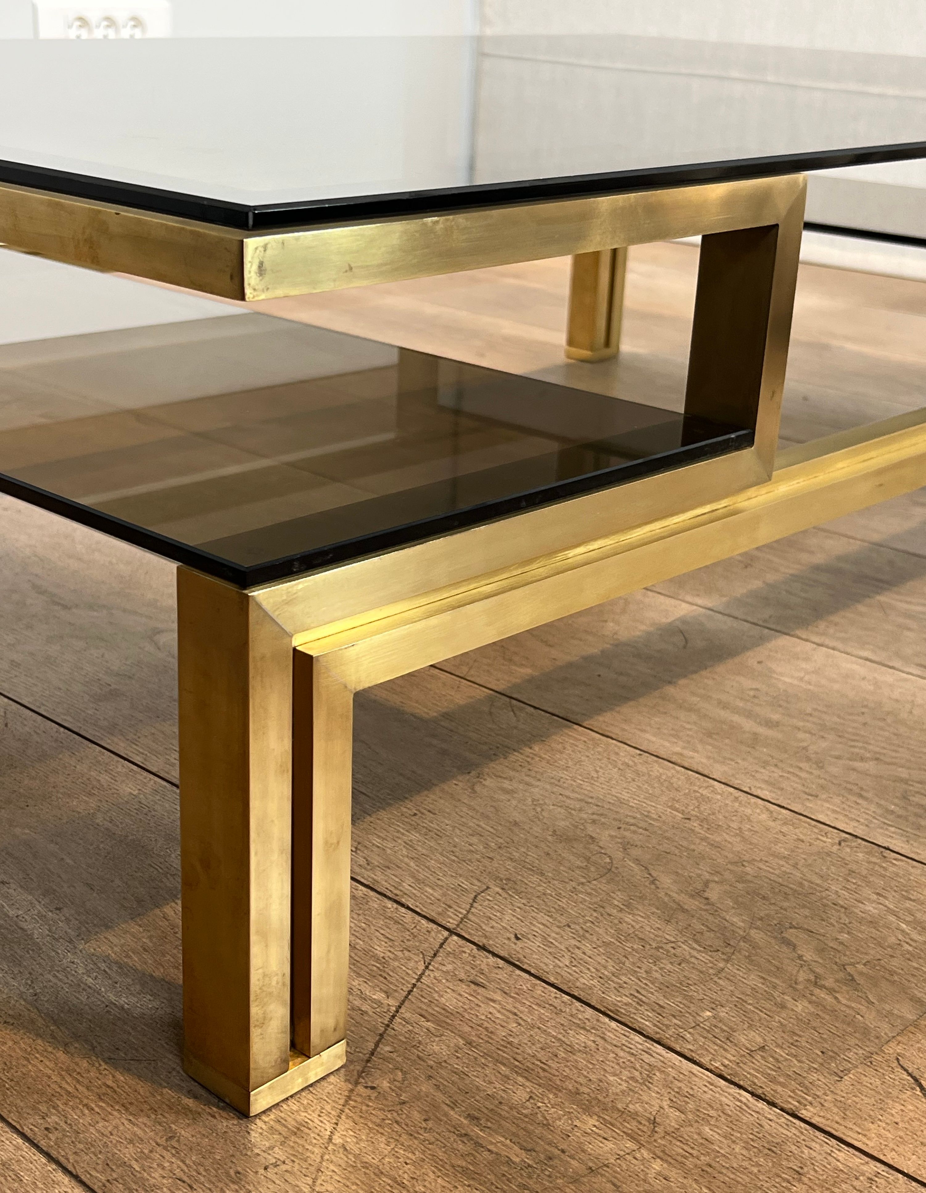 Modernist coffee table in brass and smoked glass tops by Guy Lefèvre for Maison Jansen.