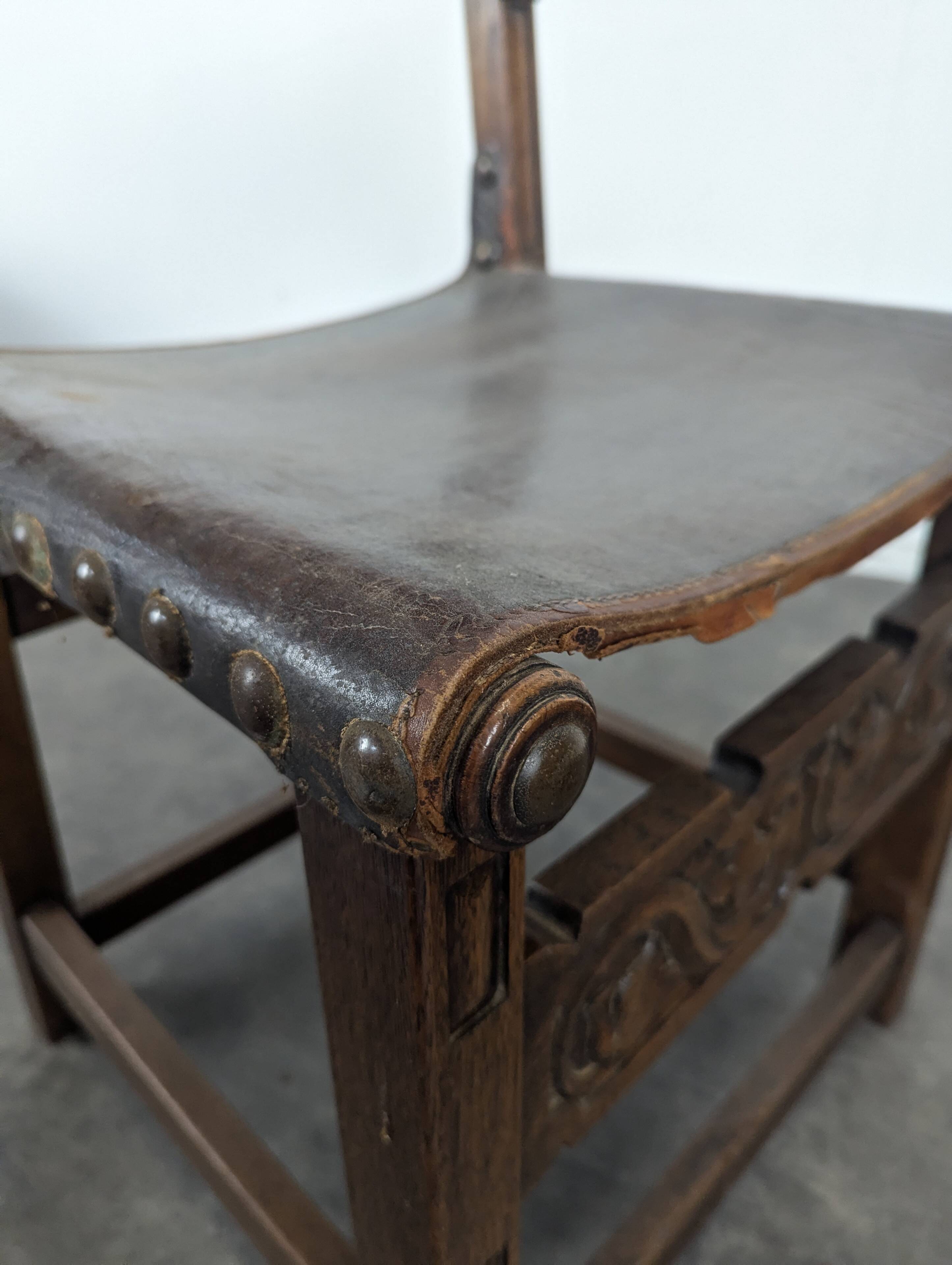 Set of 8 Gothic-style chairs in oak and studded leather.