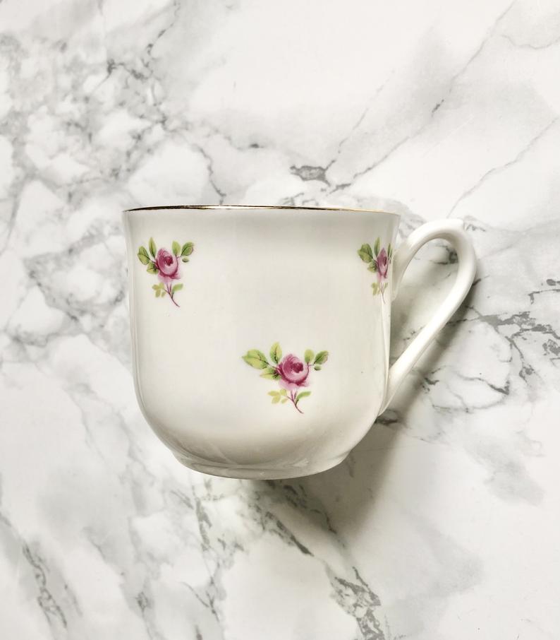 Teacup on its saucer and porcelain cake plate