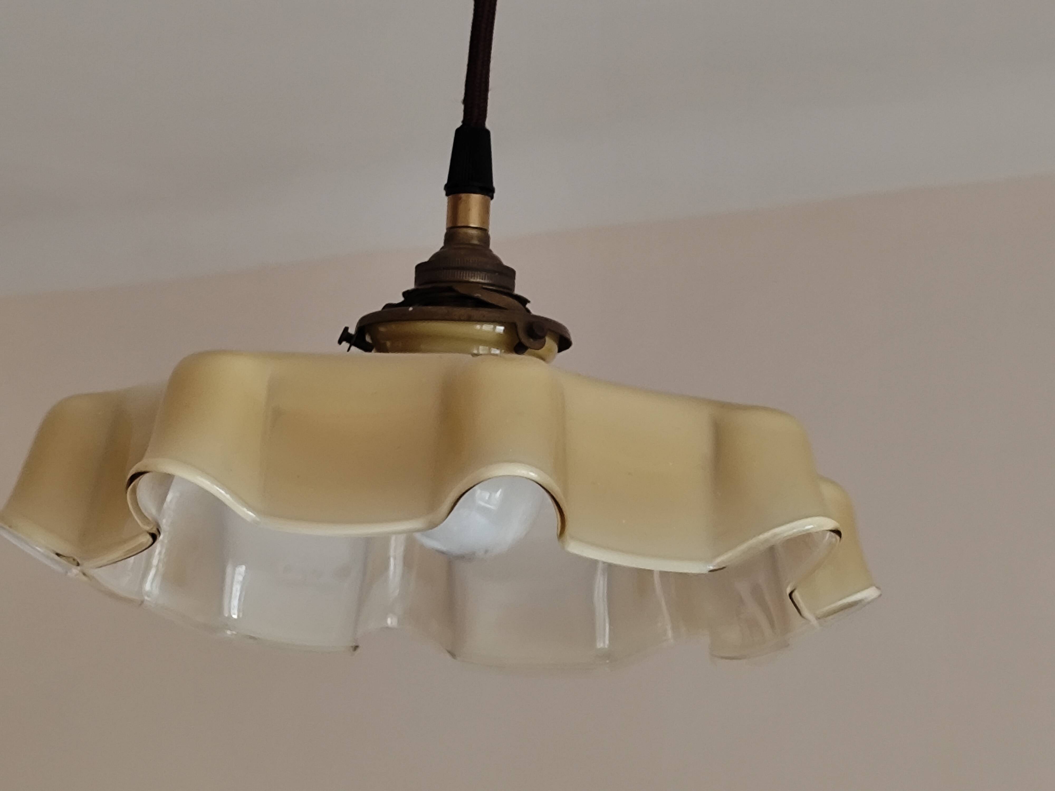 Electrified suspension with a frosted opaque glass disc shade.