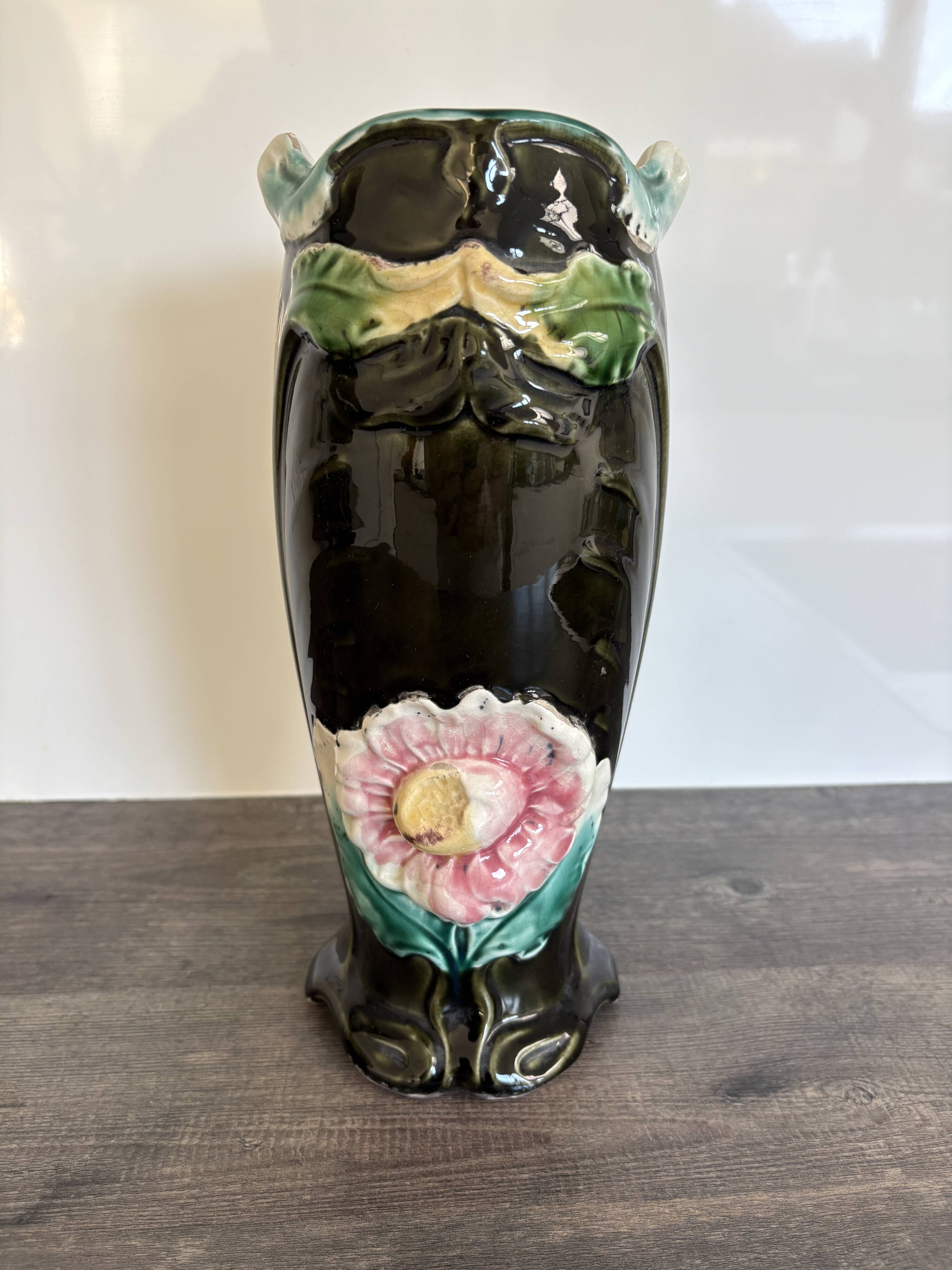 Antique ceramic vase by De Bruyn with floral decoration.