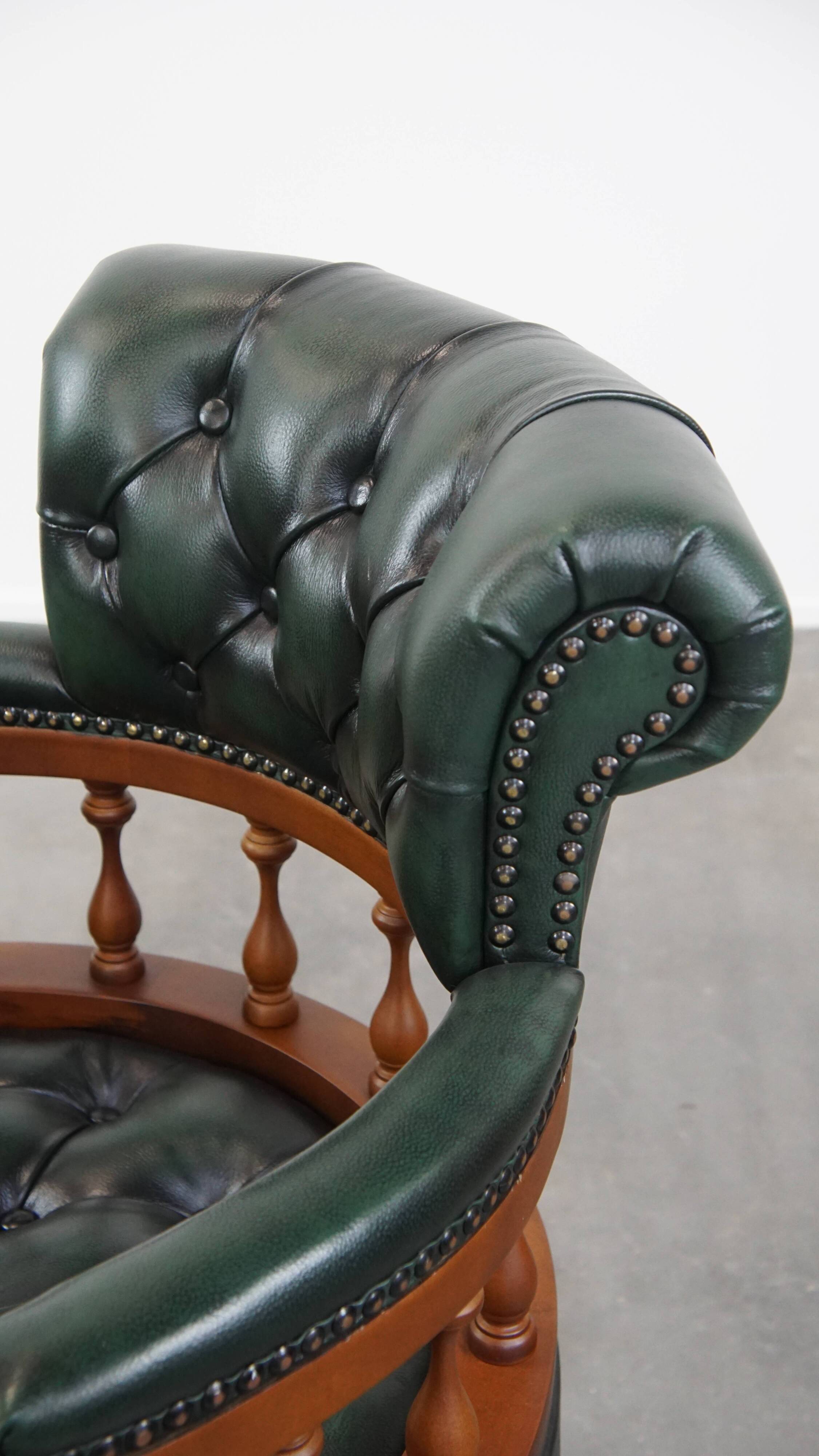 Dark green chesterfield office chair in cowhide leather on wheels