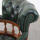 Dark green leather Chesterfield office chair on wheels.