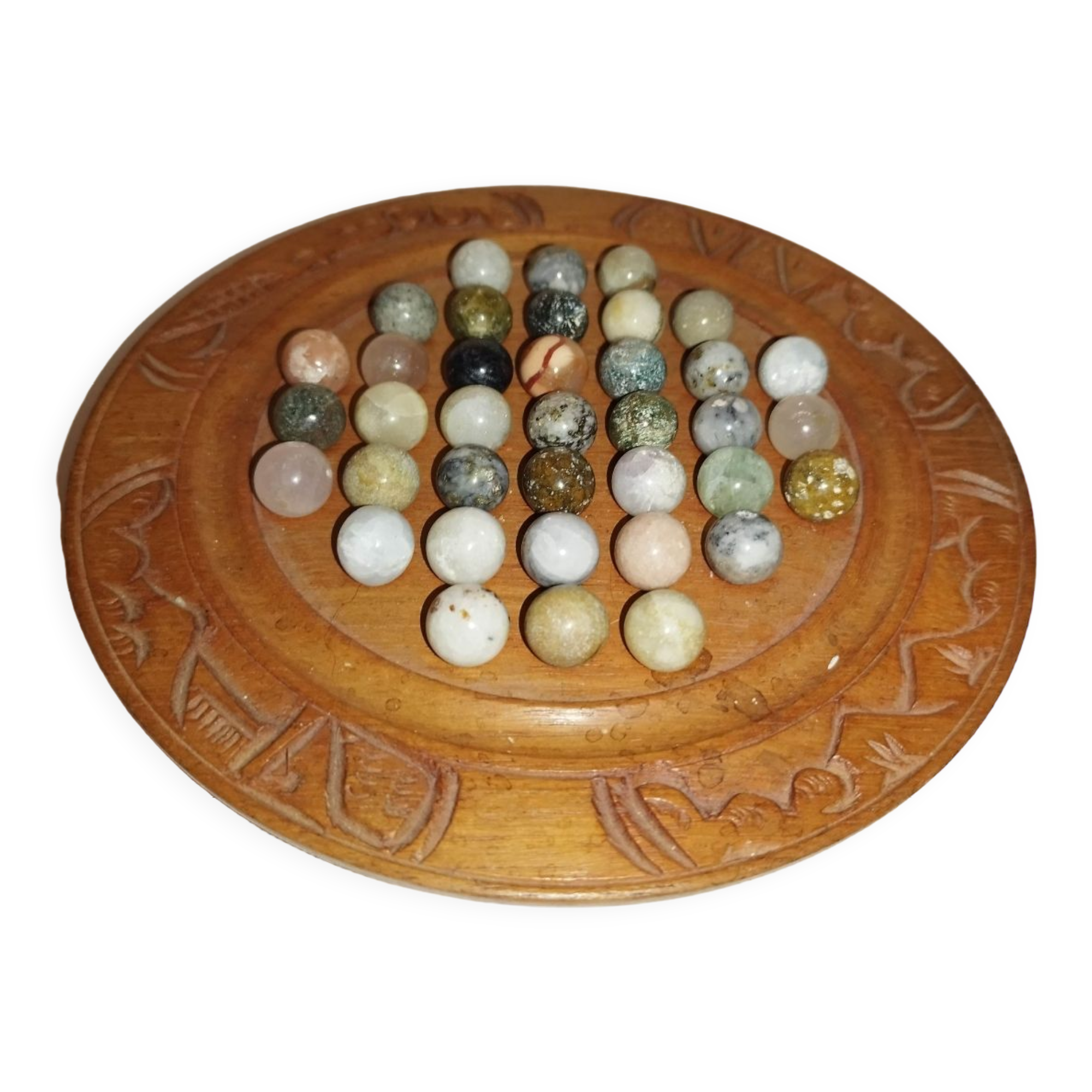 Ancient solitaire game in wood and stone marbles