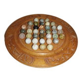 Ancient solitaire game in wood and stone marbles