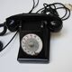 Old ptt phone with rotary dial in black bakelite