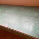 Old green wooden console with floral patterns.