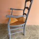 Provencal style straw armchair with gray blue patina armrests
