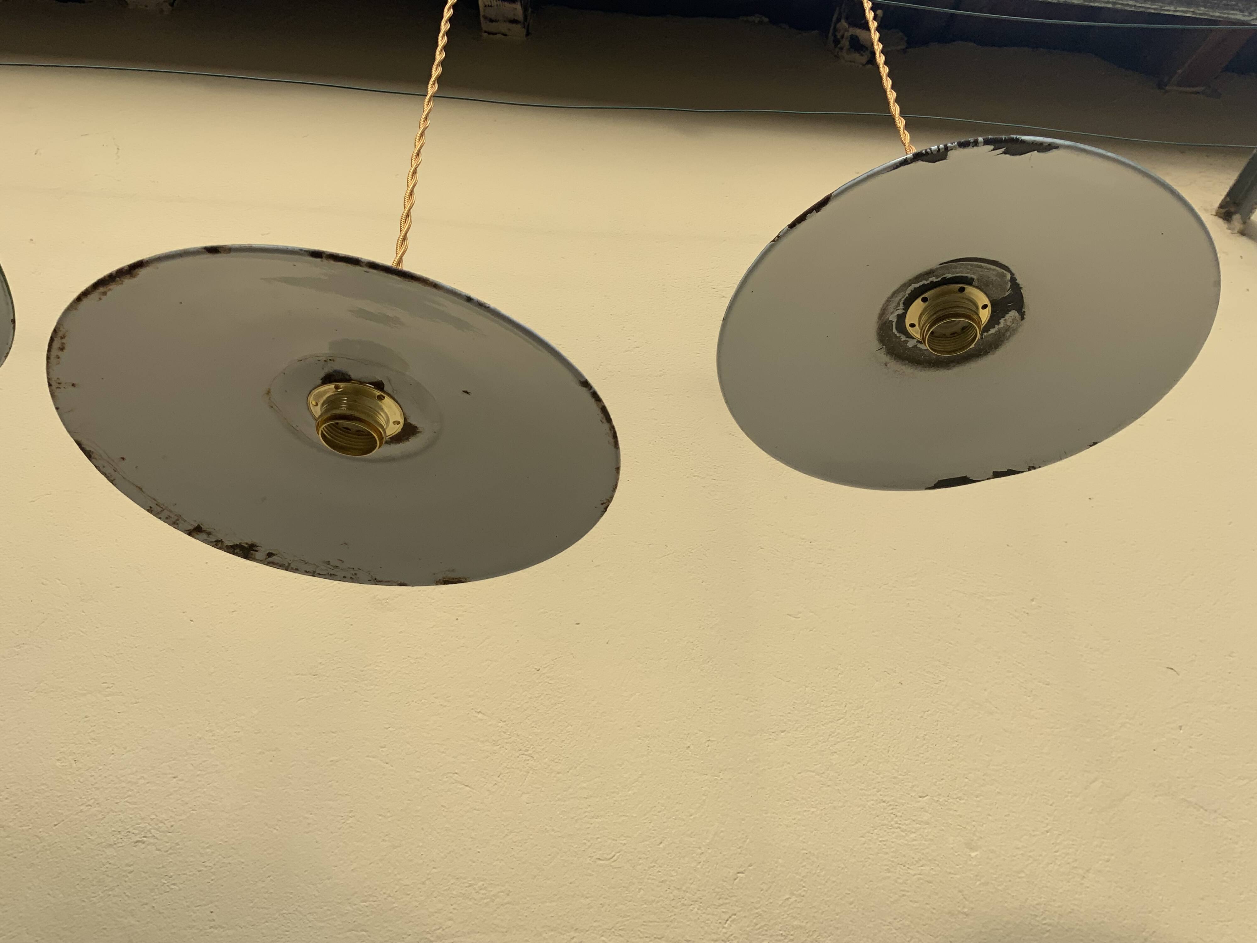 Vintage industrial enameled sheet metal pendant lights with golden wires, old green and white lampshade