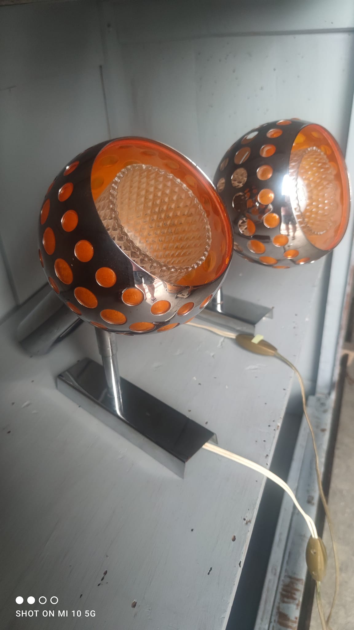 Pair of chrome-plated metal wall lights with adjustable ball joints, circa 1970