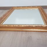 Mirror in gilded stucco wood and beveled glass