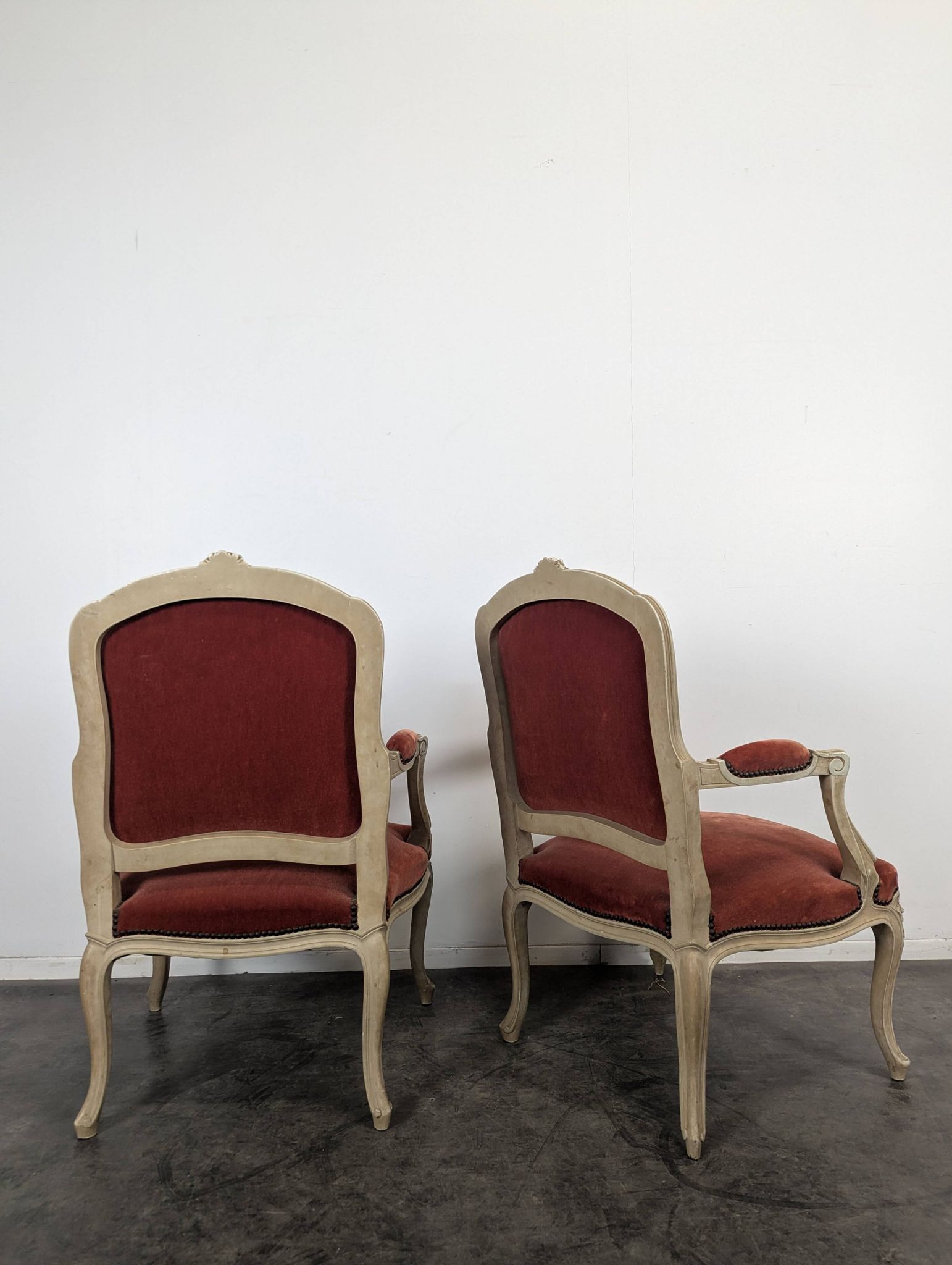 Pair of red cabriolet armchairs in Louis XV style