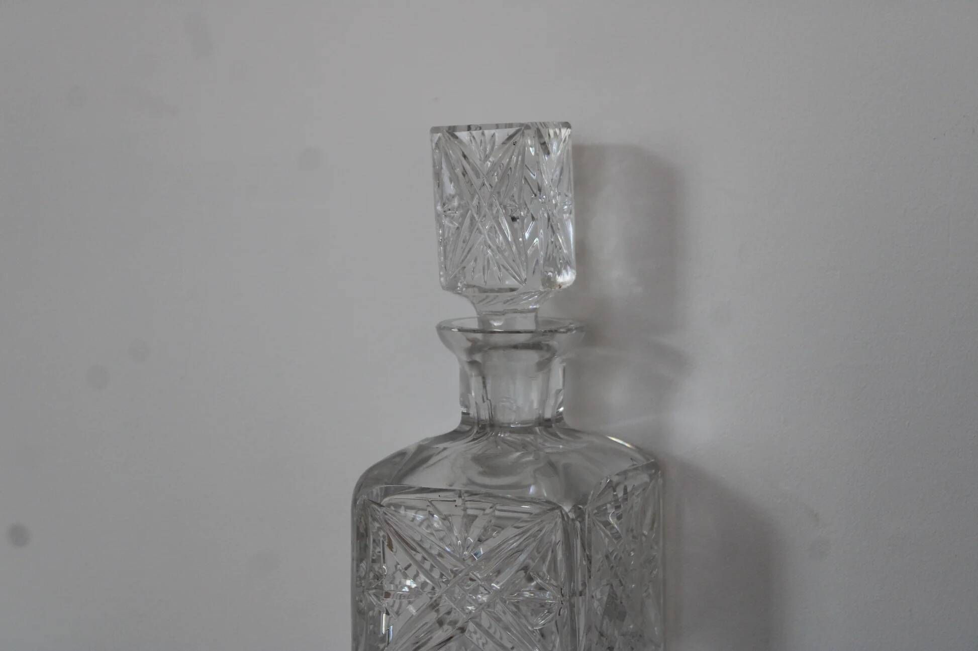 Antique cut glass carafe, probably crystal – Geometric patterns and matching stopper.