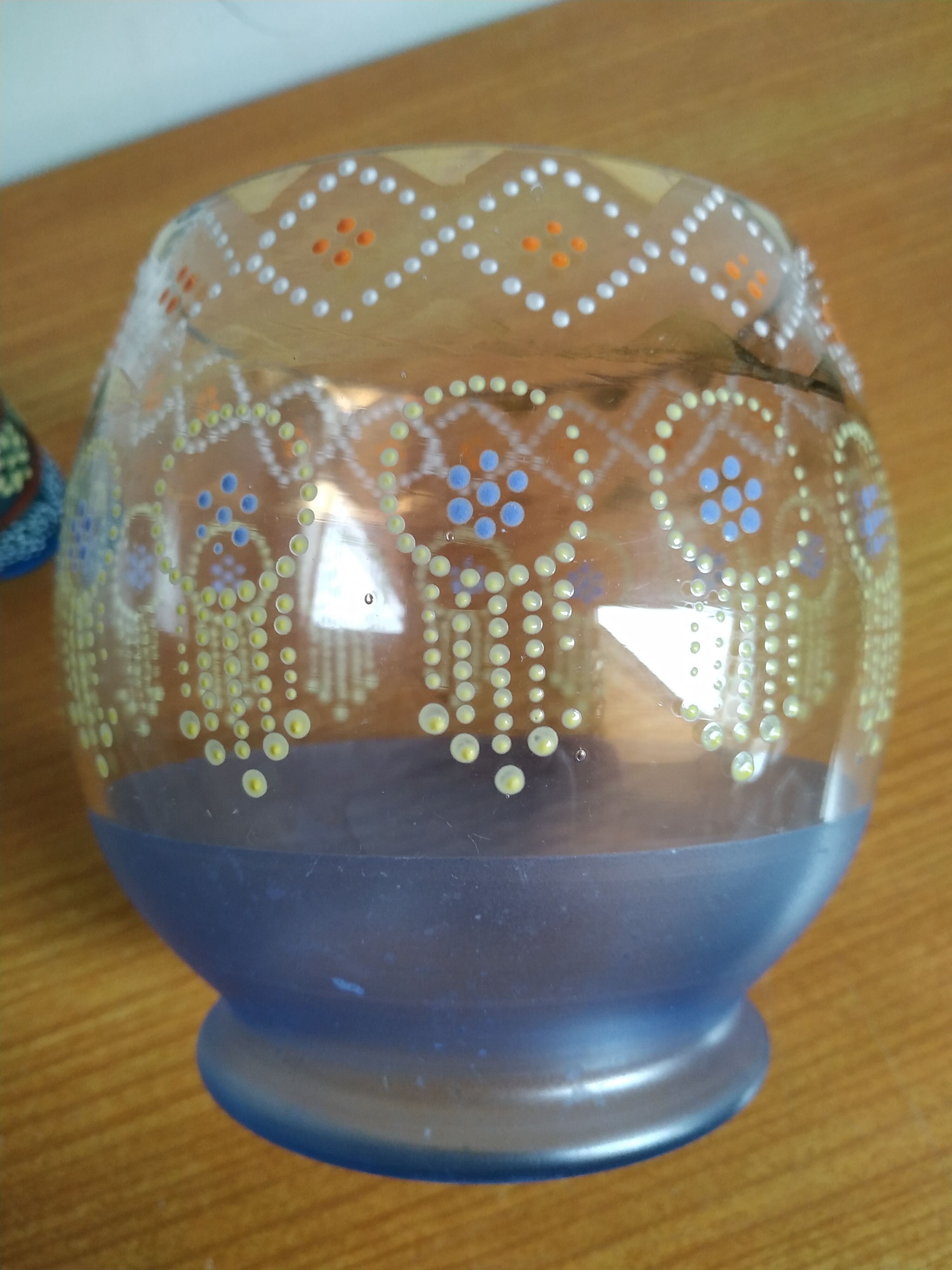 Enamelled glass ball vase decorated with beads and garlands