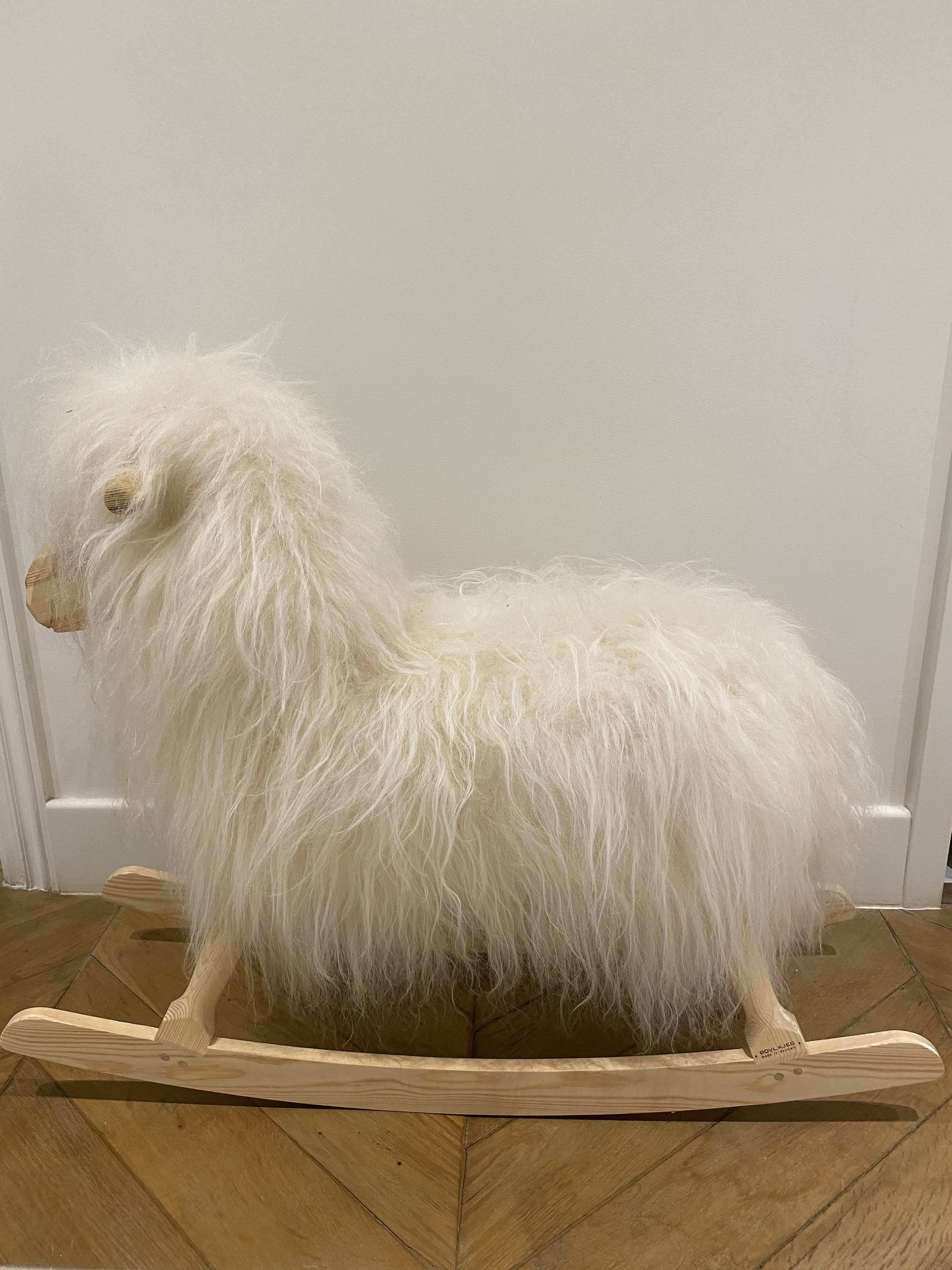Wooden rocking horse and lambskin