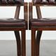 Set of two brown leather Chesterfield dining chairs in English style.