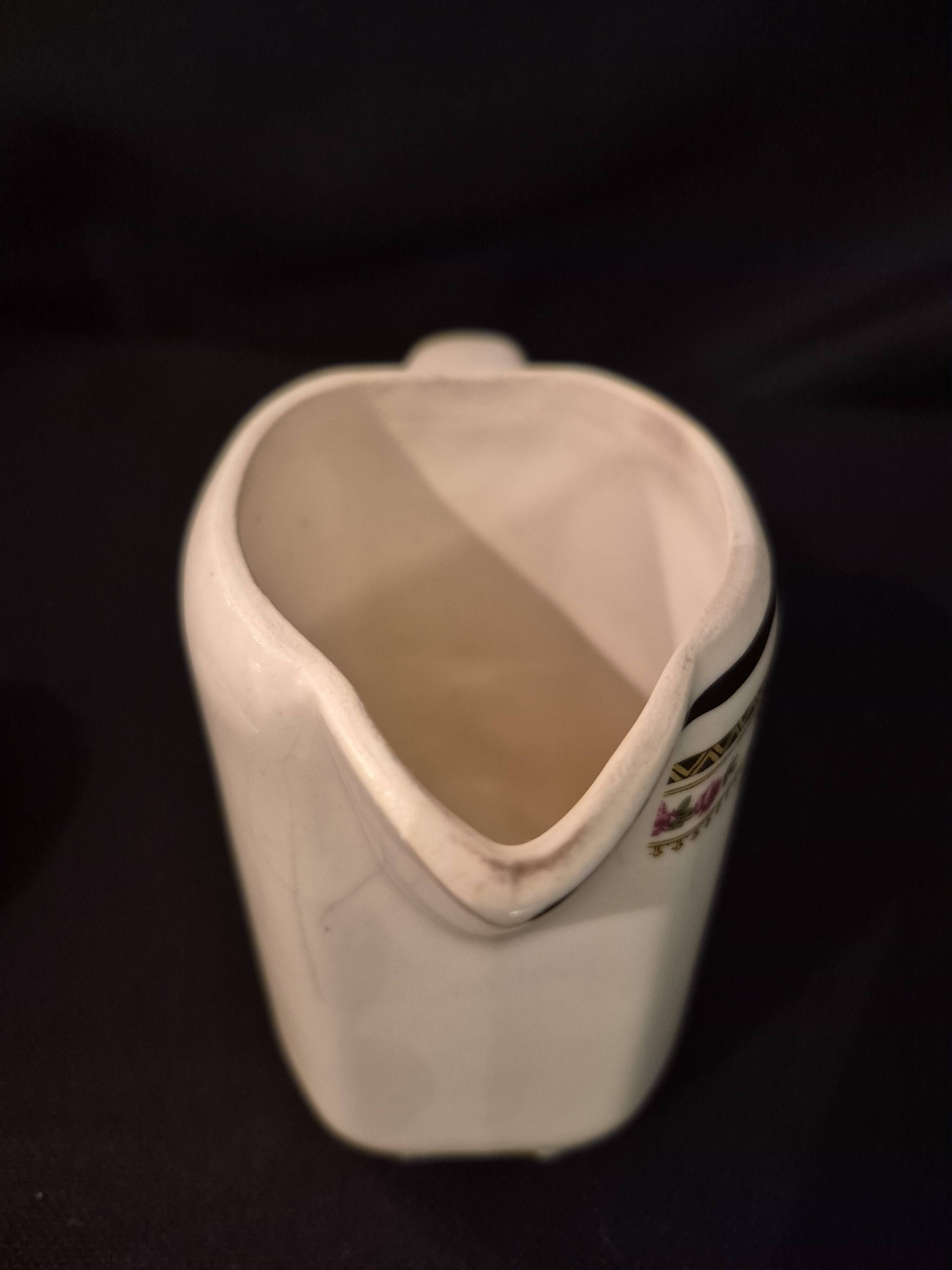 Old covered jug, vintage, geometric frieze and flowers with a border.