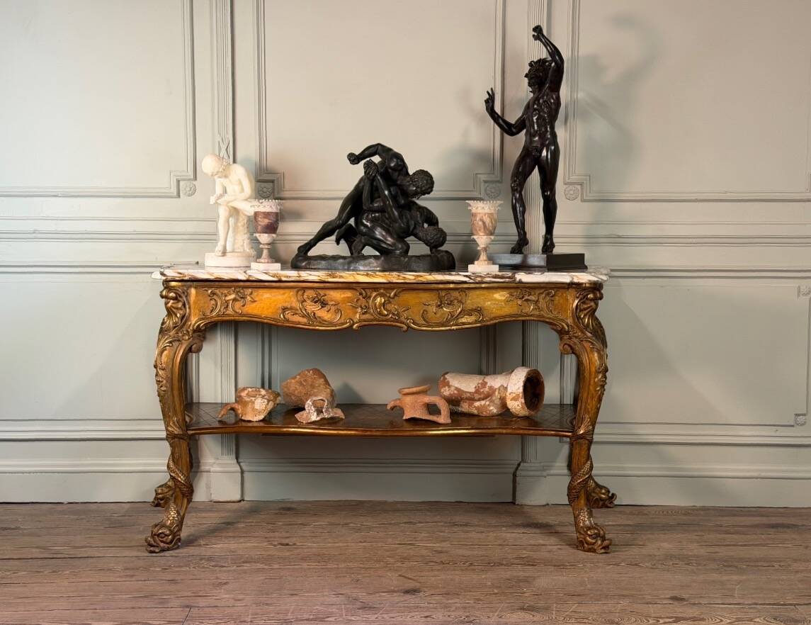 Golden wooden console, four legs adorned with sea monsters, purple breccia marble, around 1900.