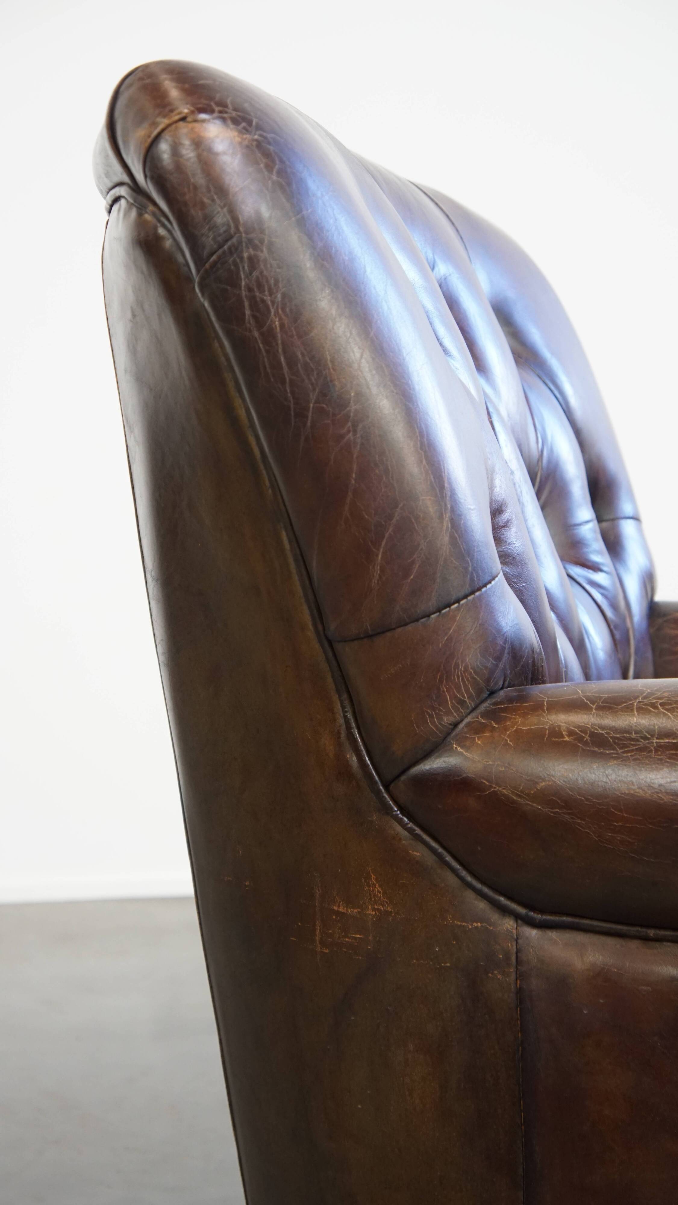 Cognac colored brown grained cowhide chesterfield armchair