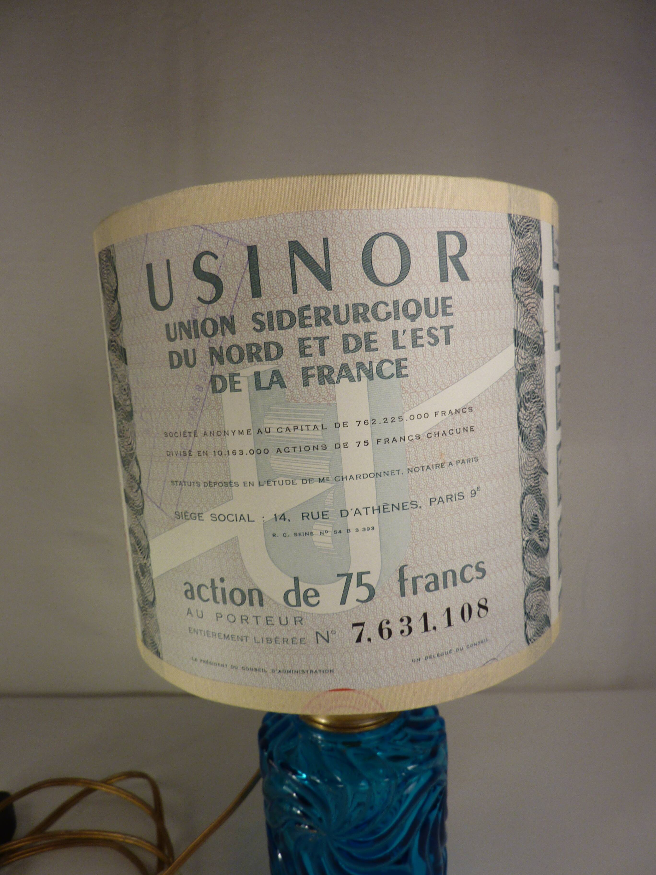 Table lamp with king blue and gold glass foot and machineinor action lampshade