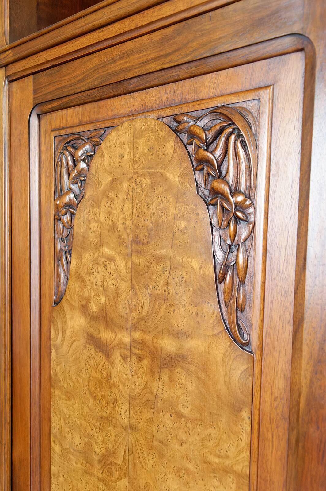 Art Deco showcase bookcase in carved walnut, France, circa 1925