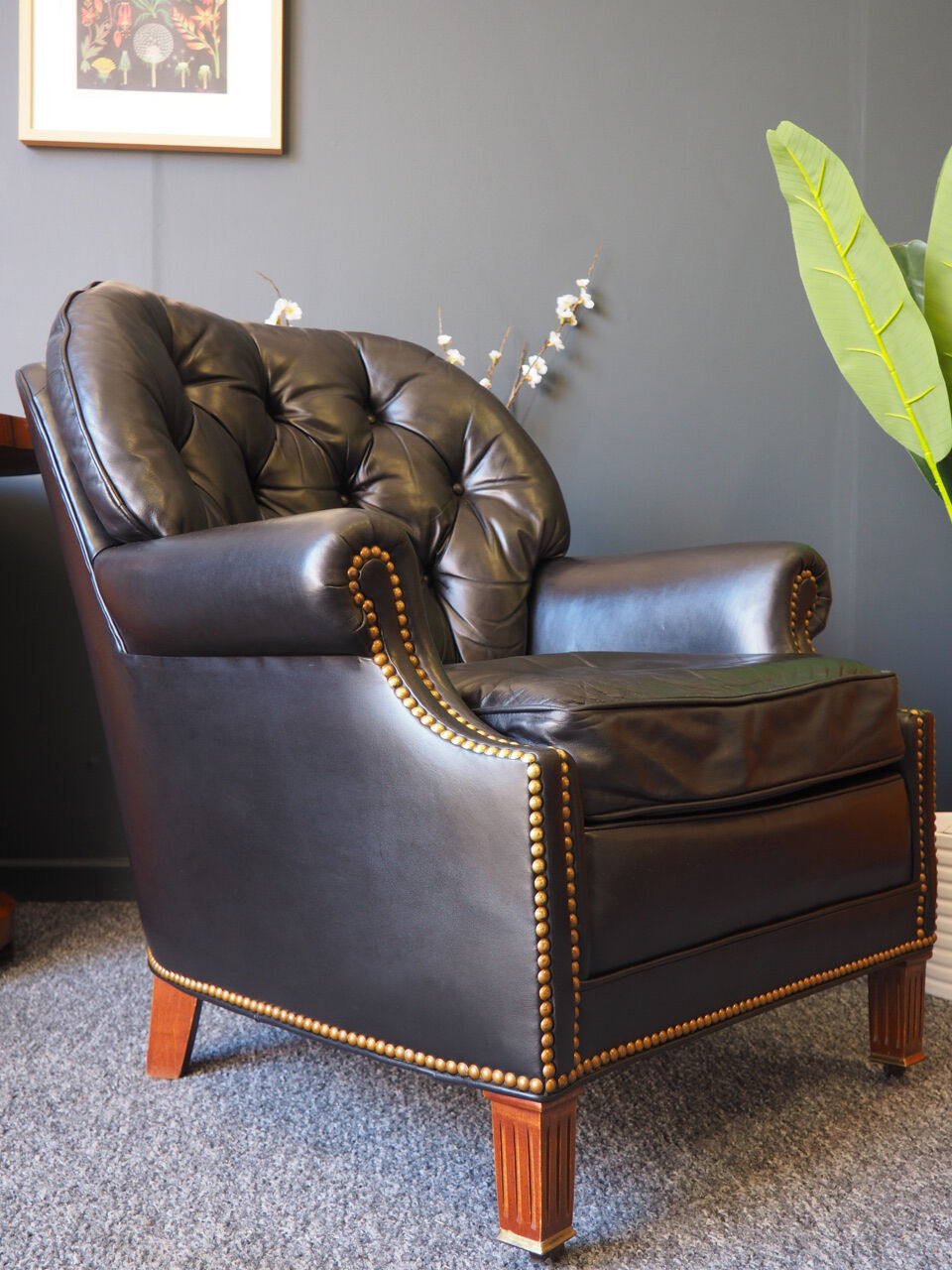 Chesterfield style leather armchair & footstool by Hancock & Moore