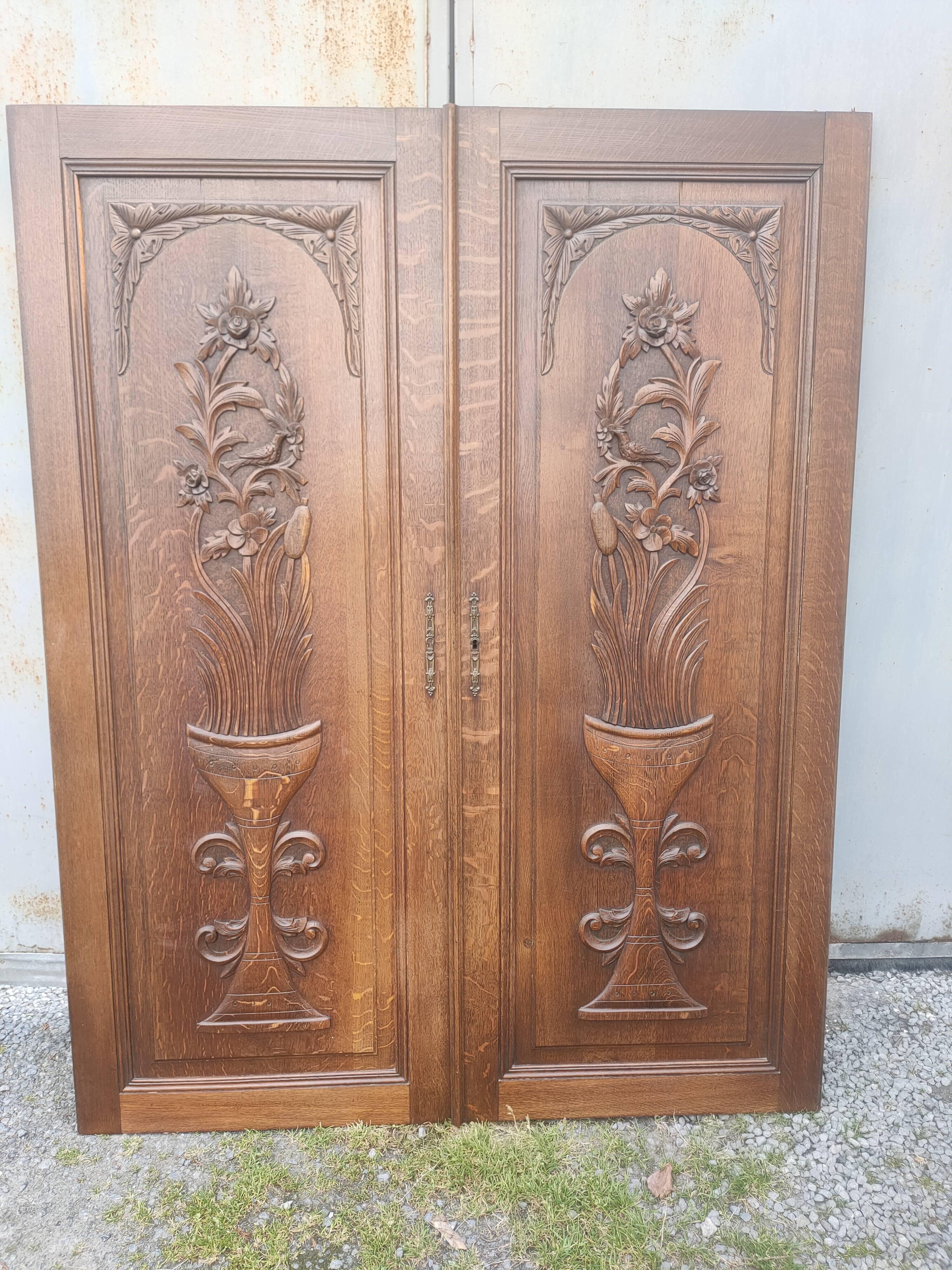 pair of antique solid oak cabinet doors with bird decor