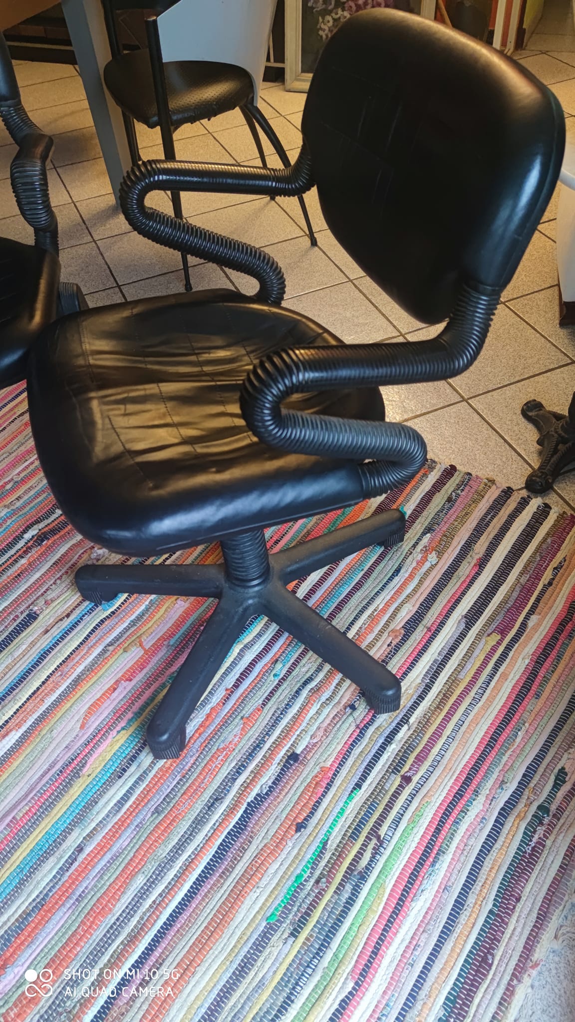 Two black leather armchairs