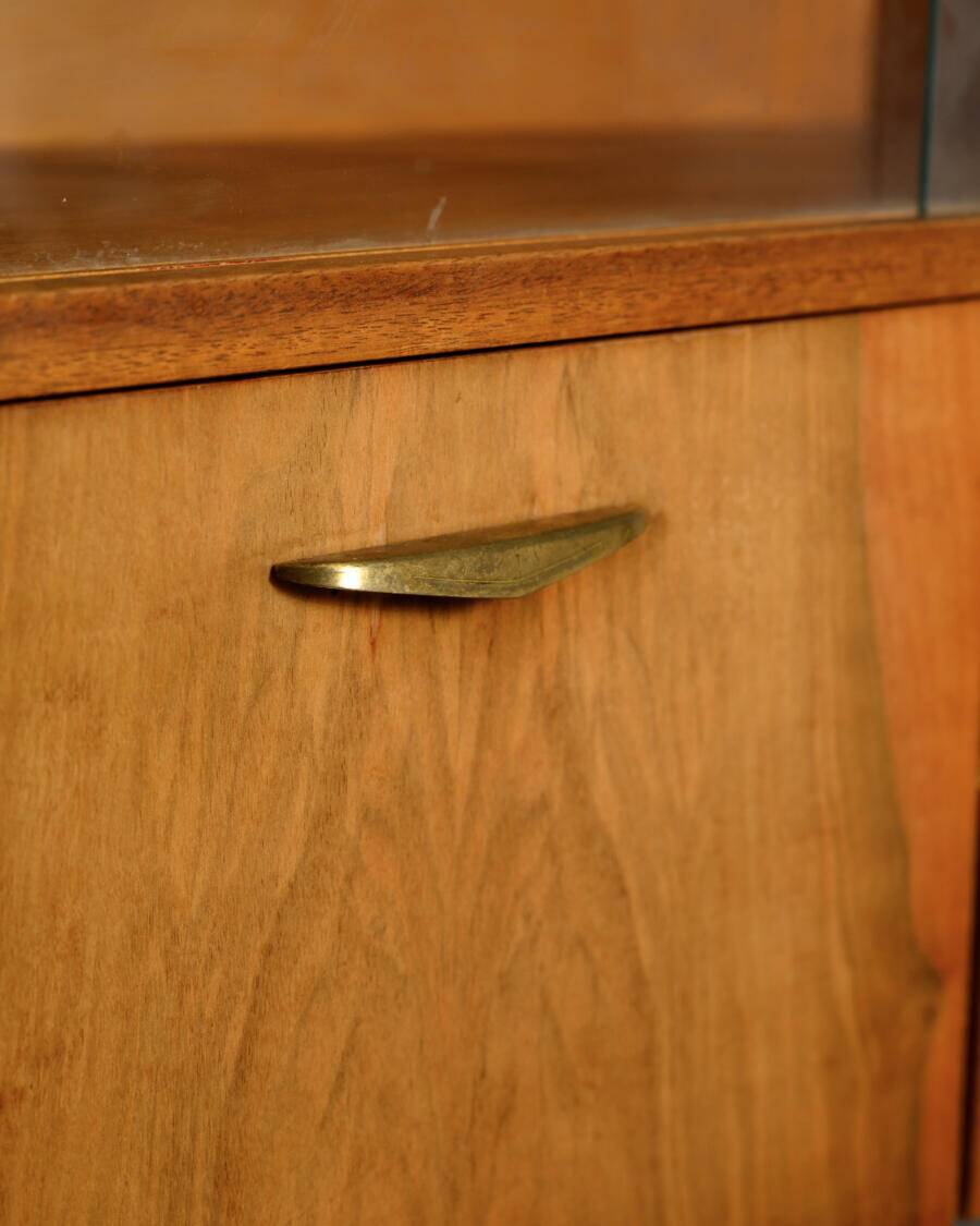 Old TV cabinet with brass handles.