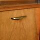 Old TV cabinet with brass handles.