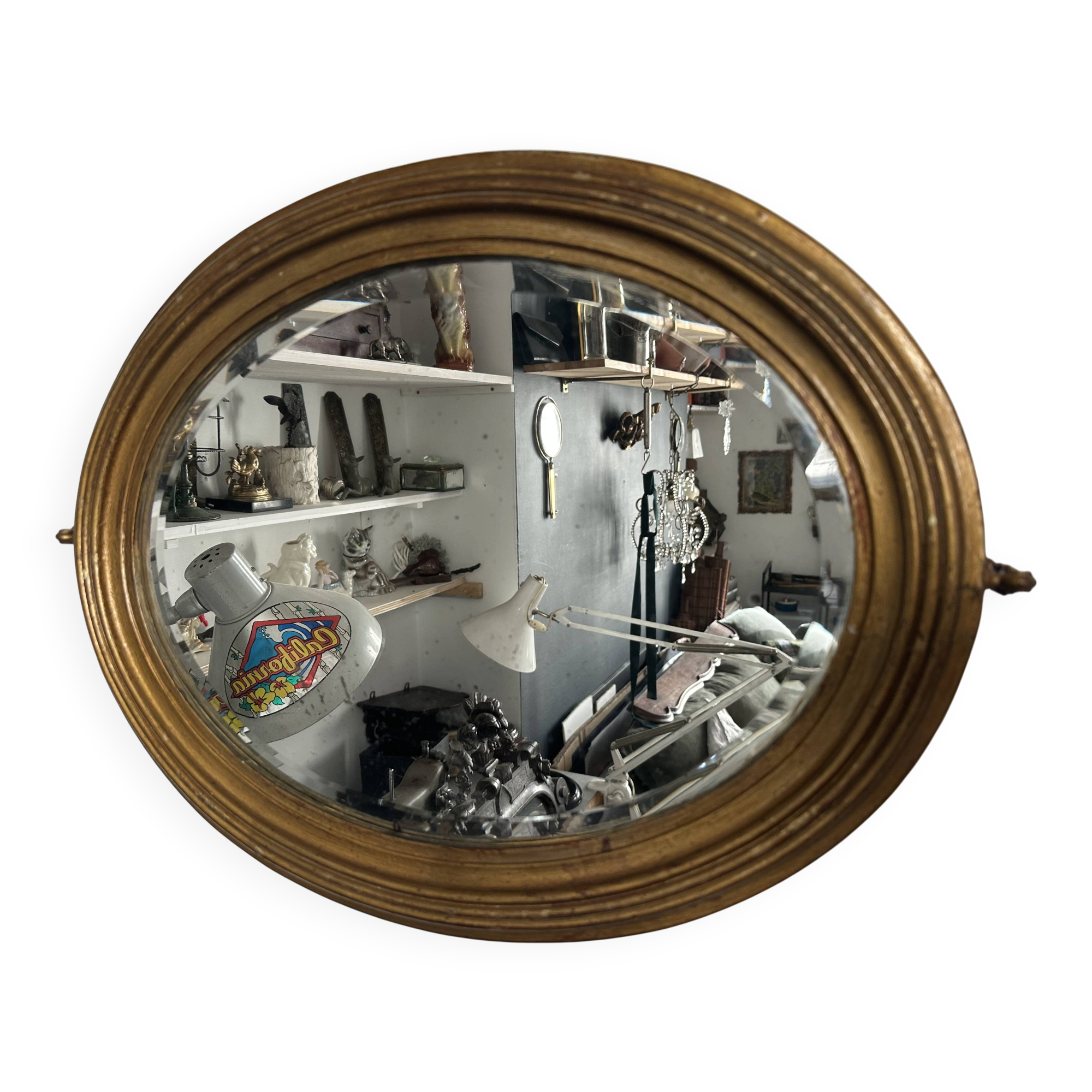 Antique oval mirror in gilded wood, bevelled mercury glass, 19th century.