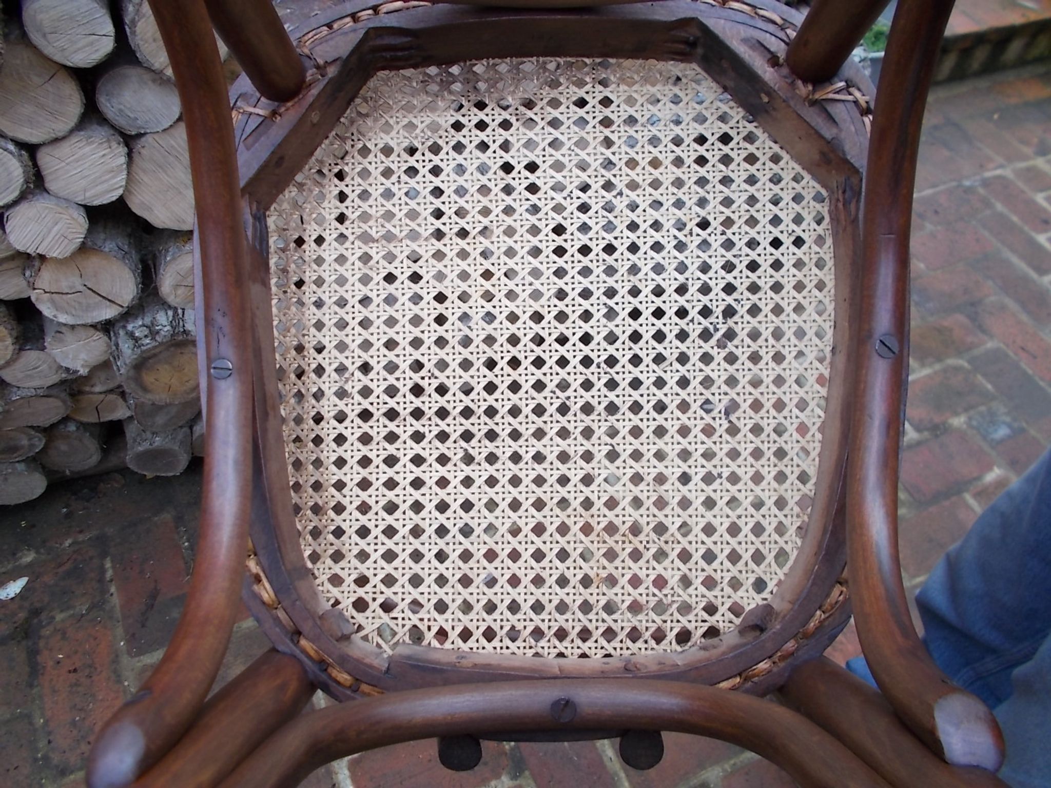 Curved wooden bistro chair with caning