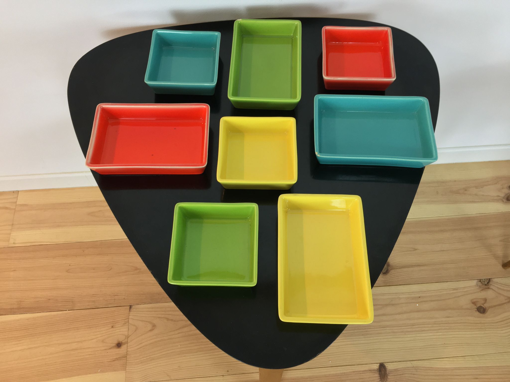 Black metal appetizer set with colorful ceramic ramekins