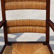 Fauteuil en  chêne teinté et paille, travail français 1950