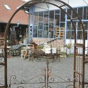 Garden arch with wrought iron gate