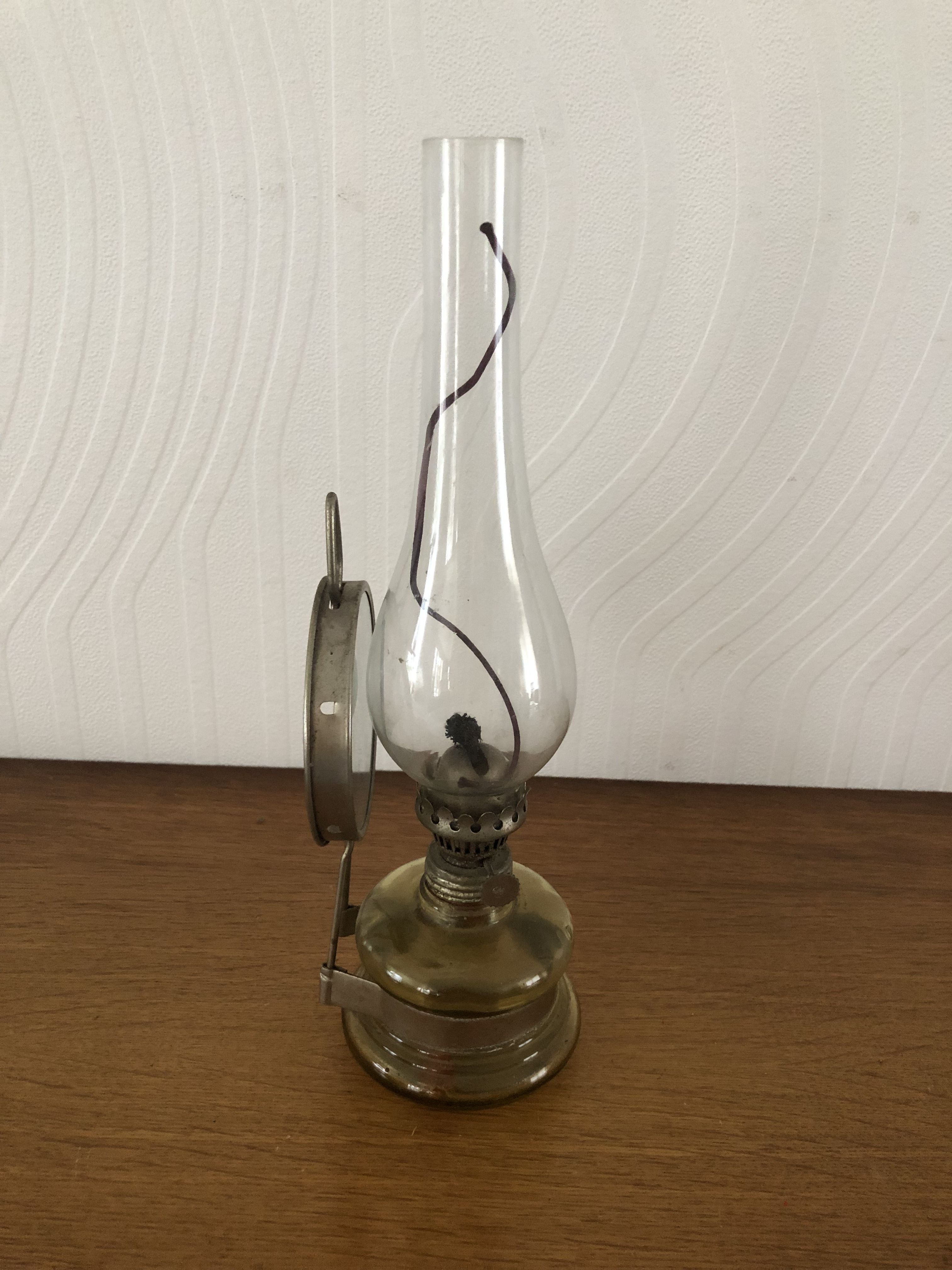 Oil lamp with glass pedestal and integrated round mirror
