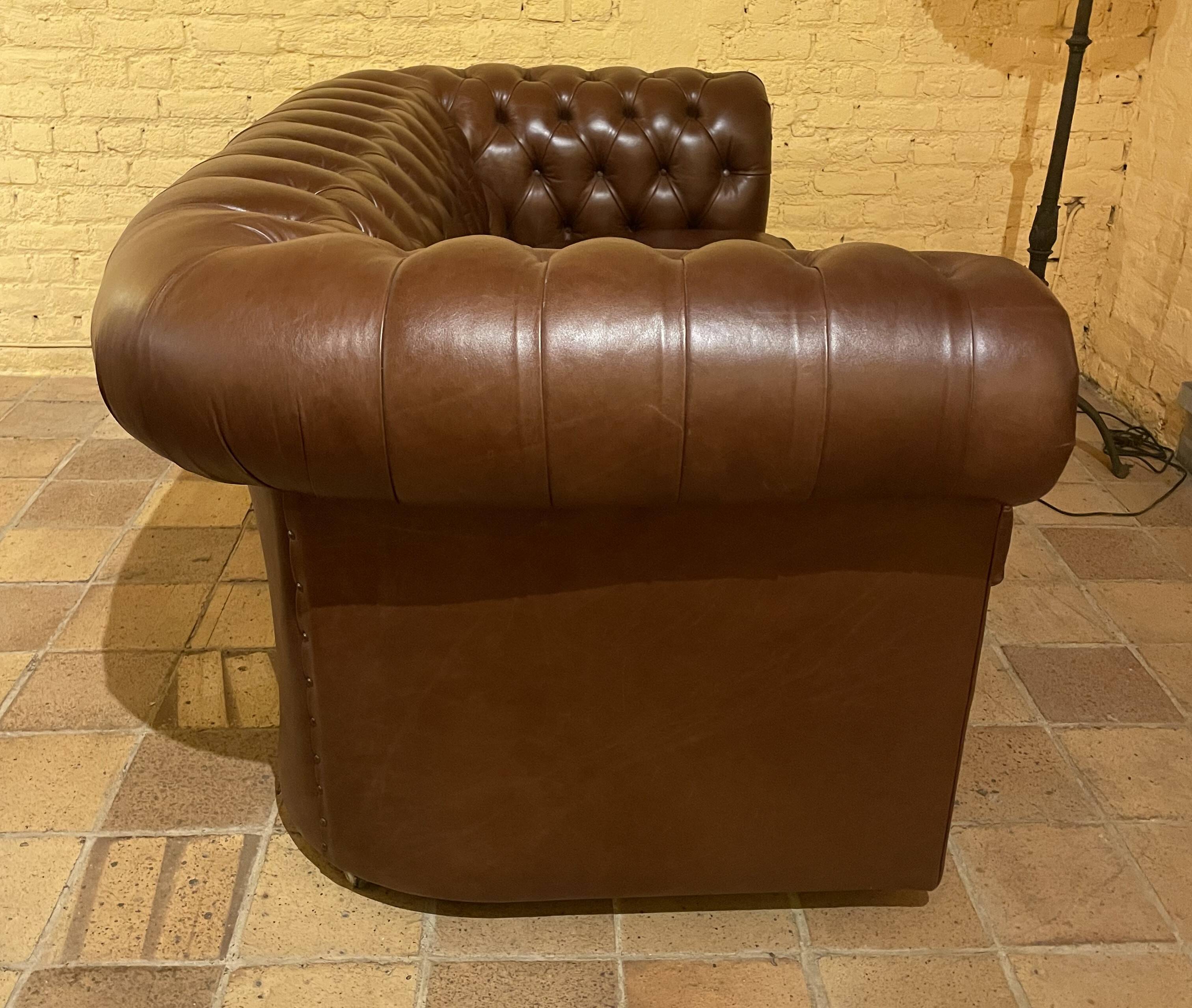 brown leather 2-seater Chesterfield sofa