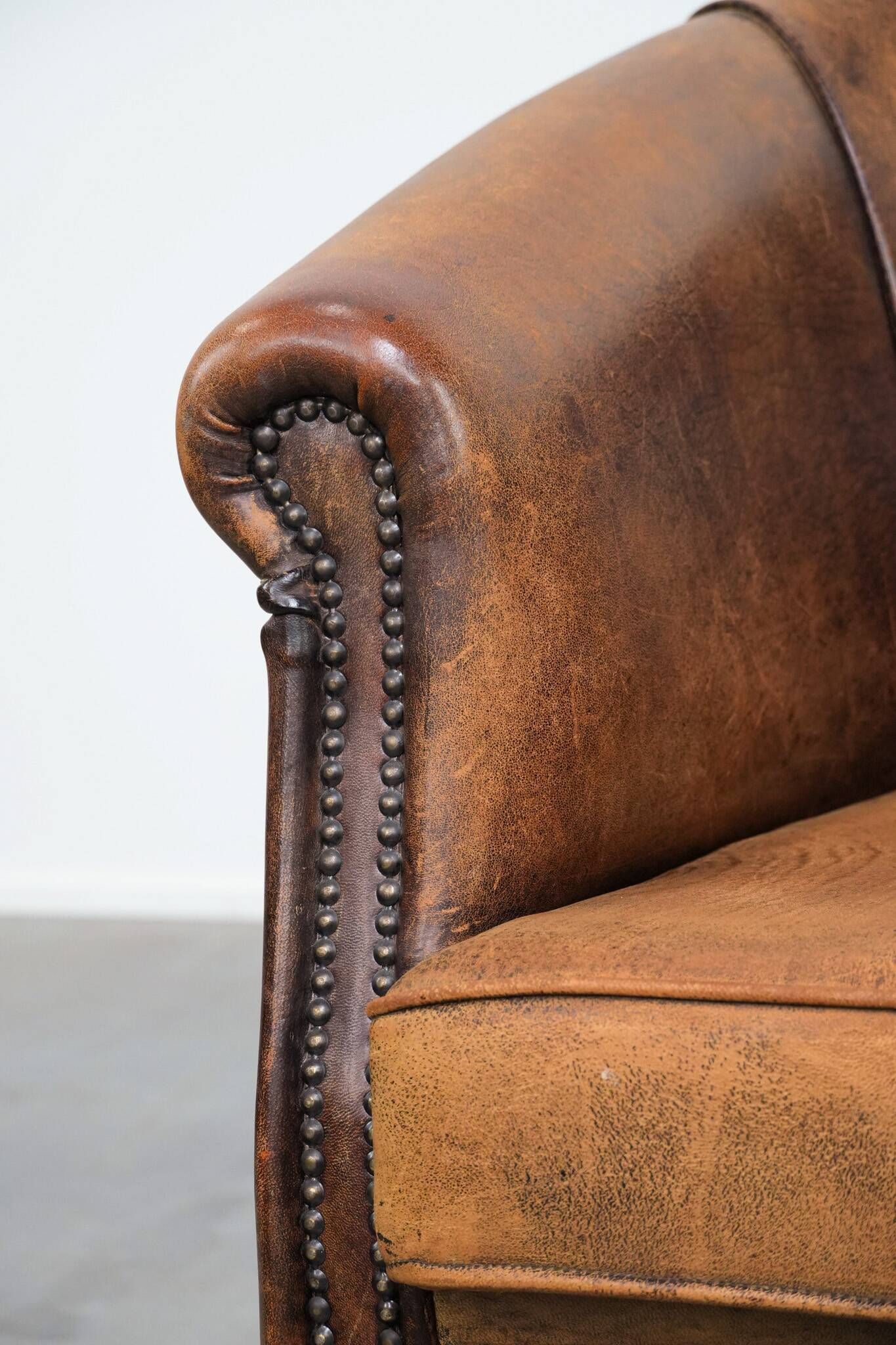 Vintage club chair in sheepskin leather with a characterful look