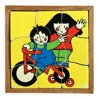 Wooden frame puzzle from the 60s/70s depicting two children on bicycles.