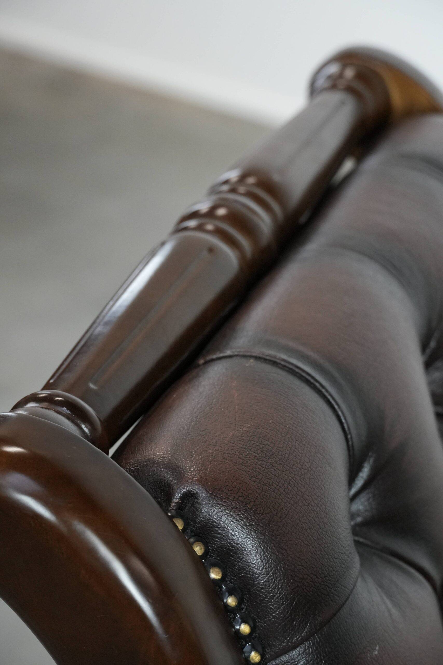 Chesterfield office chair in English style made of cow leather and wood.