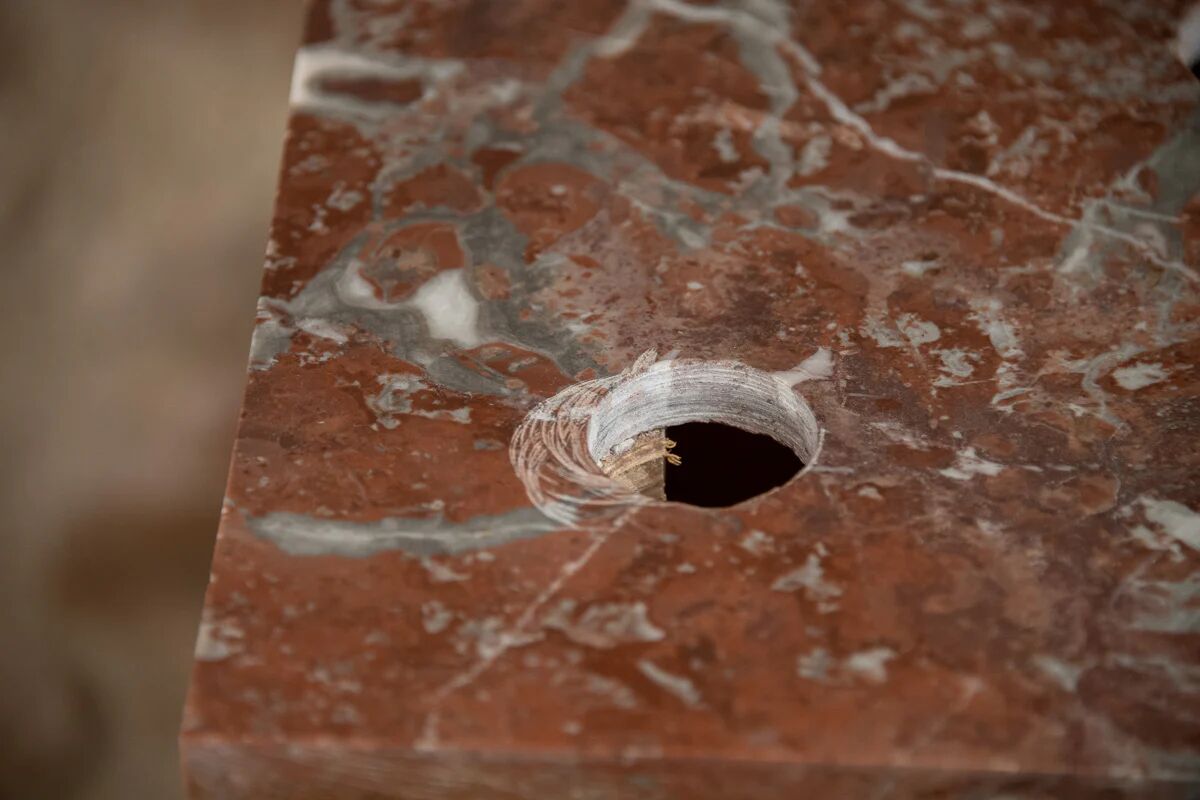 Small antique washbasin in wood and red marble.