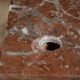 Small antique washbasin in wood and red marble.