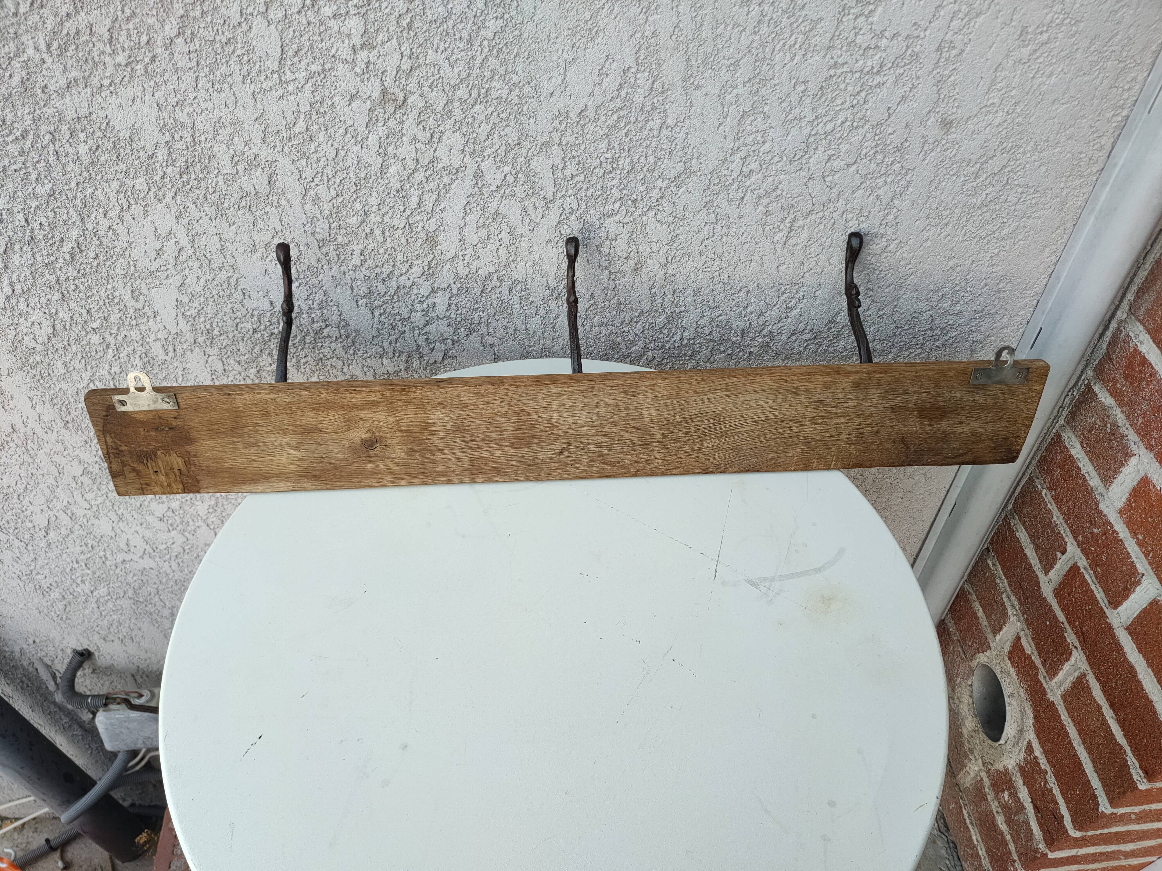 antique coat rack with 3 cast iron hooks