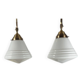 Pair of opaline glass pendant lights in white by Philips and brass from the 1920s.