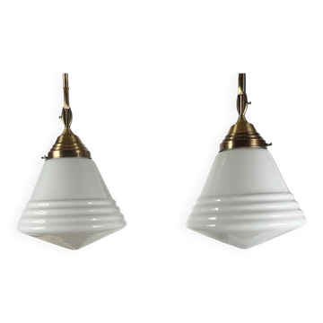Pair of opaline glass pendant lights in white by Philips and brass from the 1920s.