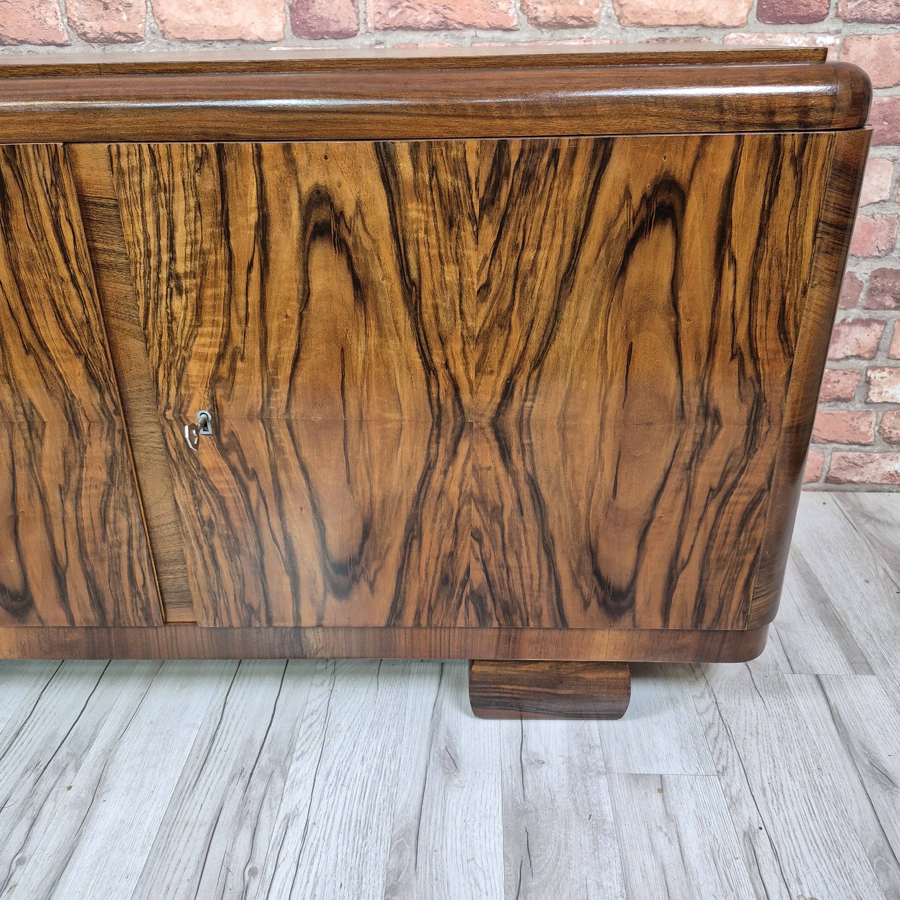Low sideboard after renovation. Hypnotising veneer and Art Deco style.