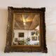 Antique Louis XV style mirror in gilded stucco.