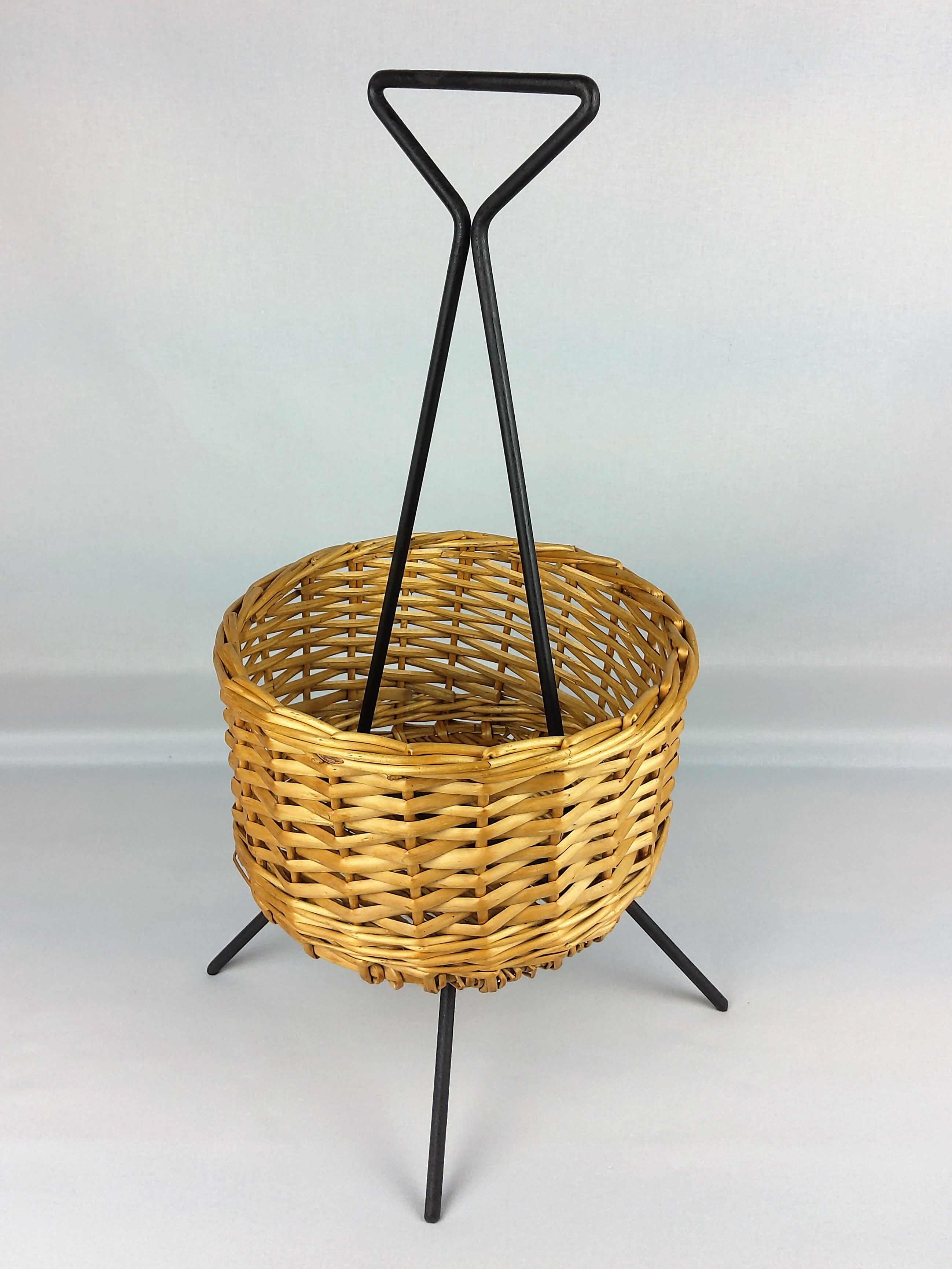 Black metal rattan trash can on 1960