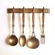 Brass and wood kitchen utensils with wall display, 60s