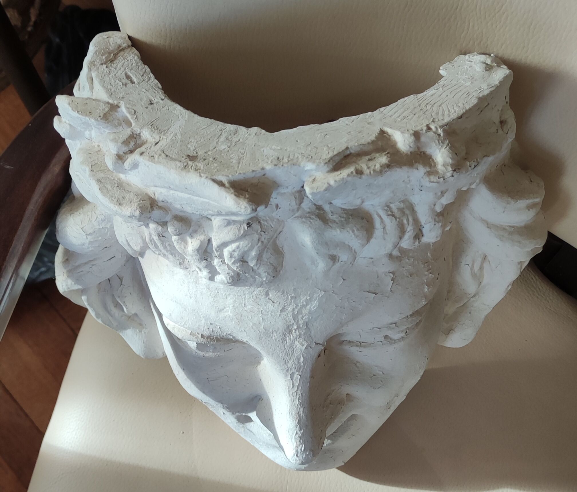 Old face in plaster antique decoration